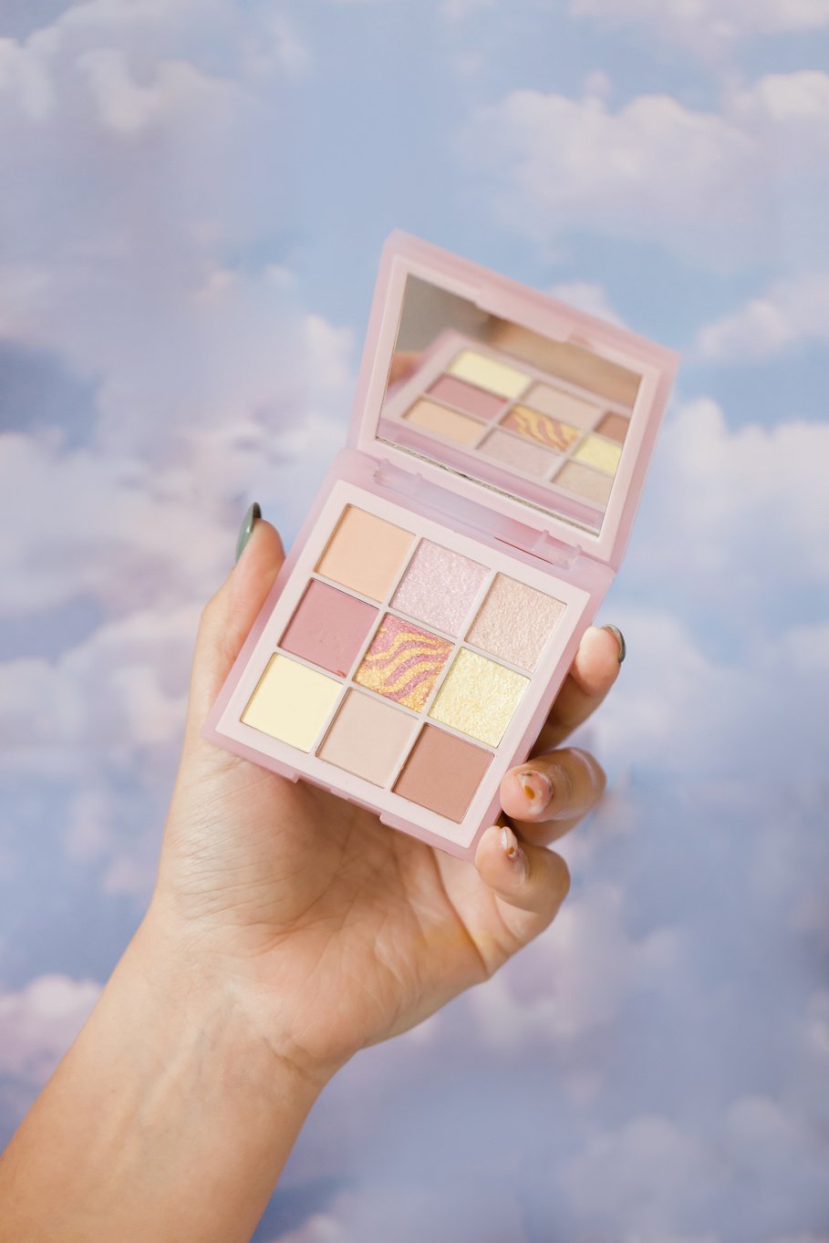 Female Hand Holding an Eyeshadow Palette