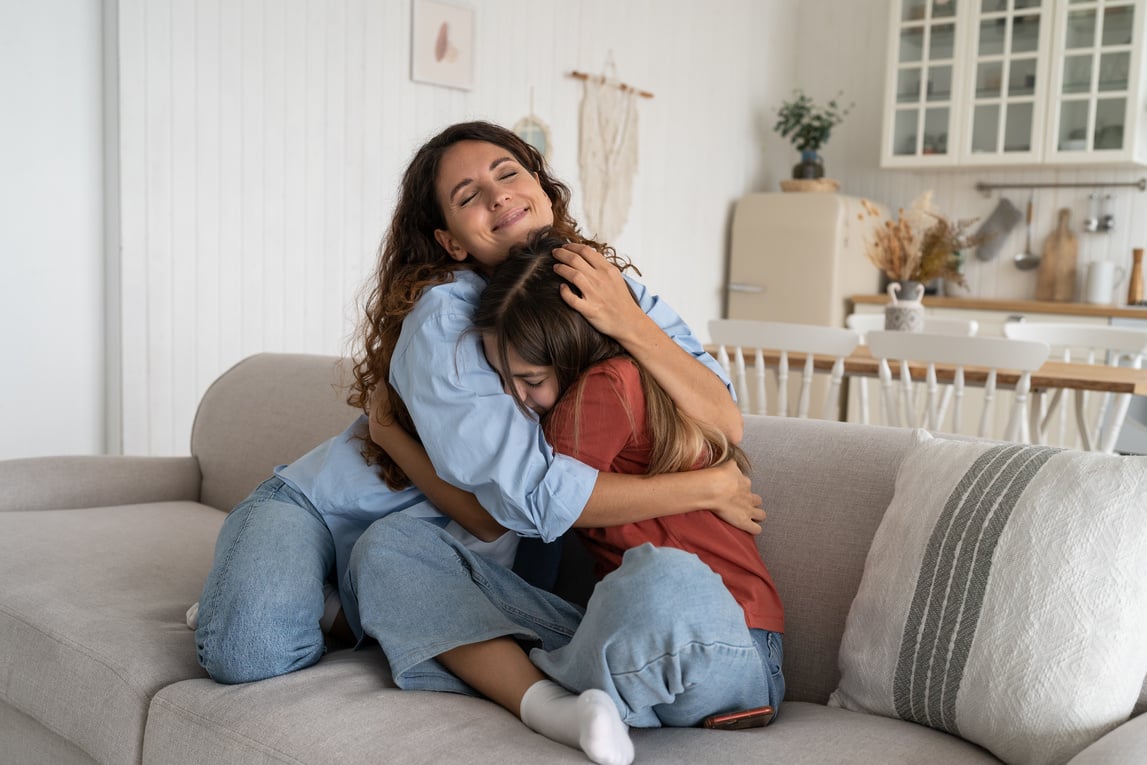 Smiling Supportive Young Mother Hugging Cuddling Teen Daughter, Mom Parent Supporting Teenage Girl